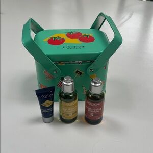 L’Occitane Tin Travel Box w handles. 
Includes 3 samples. Great for travel.